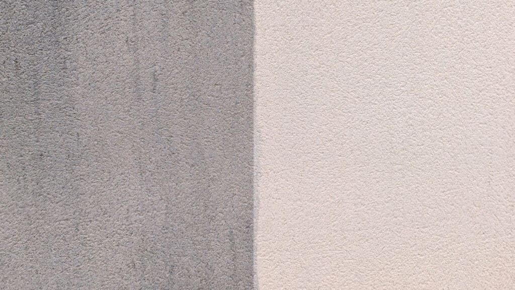 Mur Texturé : Contraste Saisissant Propre et Sale Mur extérieur texturé montrant une démarcation nette: côté gauche gris-sale, côté droit beige clair et propre.